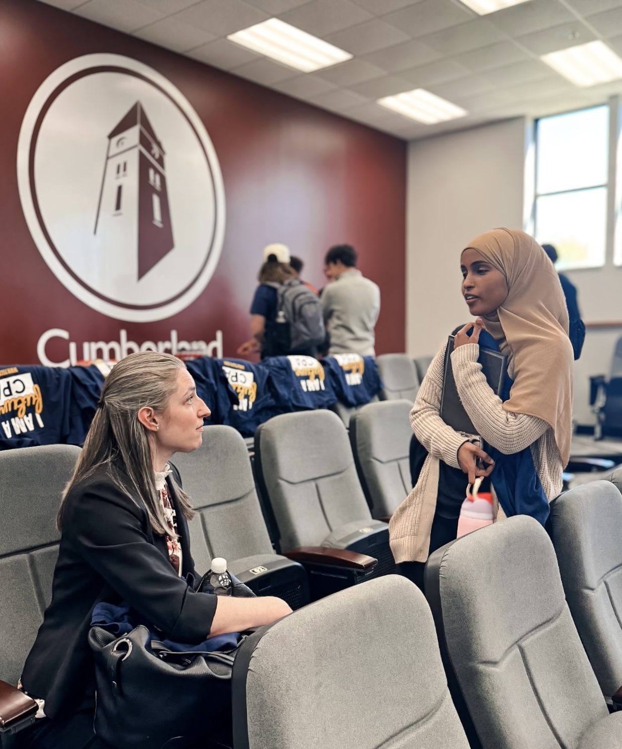 Rebecca Jennings talking with a student at the event.